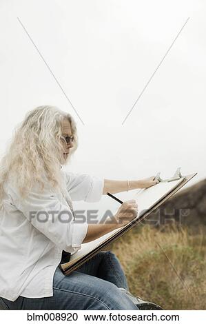 Caucasian woman drawing outdoors View Large Photo Image Stock Image - Caucasian woman drawing outdoors. Fotosearch
