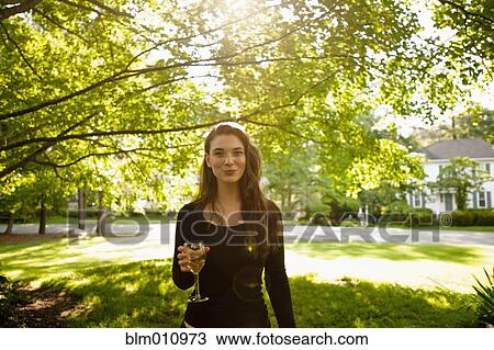 Caucasian woman drinking white wine in park View Large Photo Image Stock Image - Caucasian woman drinking white wine in park. Fotosearch