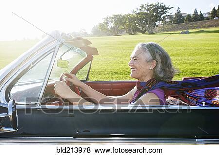 Caucasian woman driving classic convertible View Large Photo Image Stock Photo - Caucasian woman driving classic convertible. Fotosearch