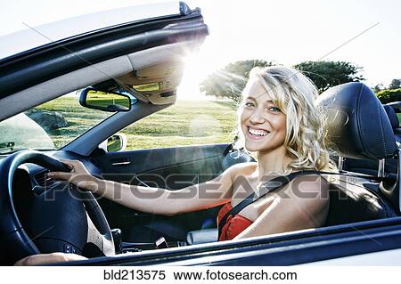 Stock Photography - Caucasian woman driving convertible. Fotosearch