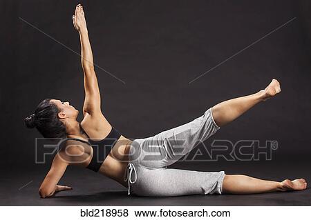 Stock Photo - Caucasian woman exercising on floor. Fotosearch