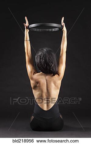 Caucasian woman exercising with resistance ring View Large Photo Image Stock Photograph - Caucasian woman exercising with resistance ring. Fotosearch