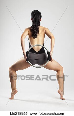 Caucasian woman exercising with resistance ring View Large Photo Image Stock Photography - Caucasian woman exercising with resistance ring. Fotosearch