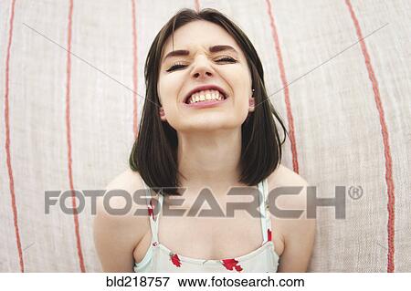 Caucasian woman grinning with bared teeth View Large Photo Image Stock Photo - Caucasian woman grinning with bared teeth. Fotosearch