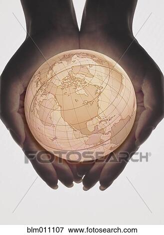Stock Photo - Caucasian woman holding globe in her hands. Fotosearch