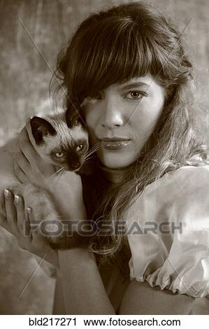Caucasian woman holding kitten View Large Photo Image Stock Image - Caucasian woman holding kitten. Fotosearch