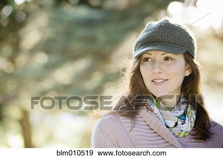 Stock Photo - Caucasian woman in cap outdoors. Fotosearch