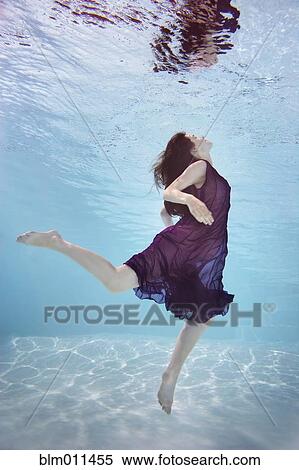 Caucasian woman in dress swimming underwater View Large Photo Image Stock Photography - Caucasian woman in dress swimming underwater. Fotosearch