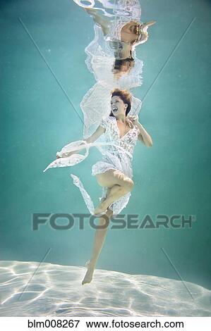 Caucasian woman in elegant dress under water View Large Photo Image Stock Photo - Caucasian woman in elegant dress under water. Fotosearch
