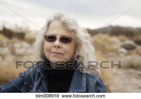 Stock Photo - Caucasian woman in sunglasses outdoors. Fotosearch