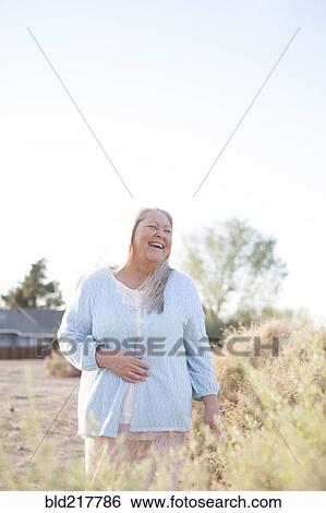 Caucasian woman laughing in backyard View Large Photo Image Stock Photograph - Caucasian woman laughing in backyard. Fotosearch