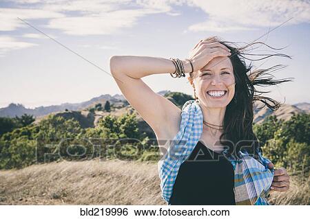 Caucasian woman laughing in rural field View Large Photo Image Stock Photograph - Caucasian woman laughing in rural field. Fotosearch