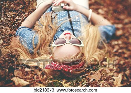 Caucasian woman laying in autumn leaves View Large Photo Image Stock Image - Caucasian woman laying in autumn leaves. Fotosearch