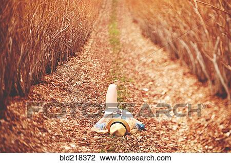 Caucasian woman laying on dirt path View Large Photo Image Stock Image - Caucasian woman laying on dirt path. Fotosearch