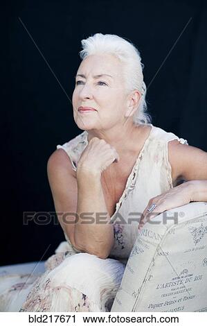 Caucasian woman leaning on chair back View Large Photo Image Stock Image - Caucasian woman leaning on chair back. Fotosearch