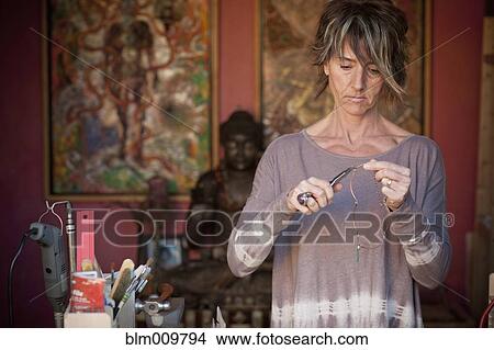 Caucasian woman making jewelry View Large Photo Image Picture - Caucasian woman making jewelry. Fotosearch