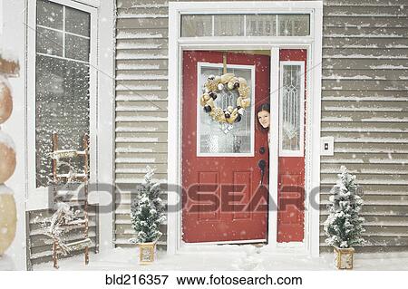 Caucasian woman opening door to snow View Large Photo Image Stock Photo - Caucasian woman opening door to snow. Fotosearch