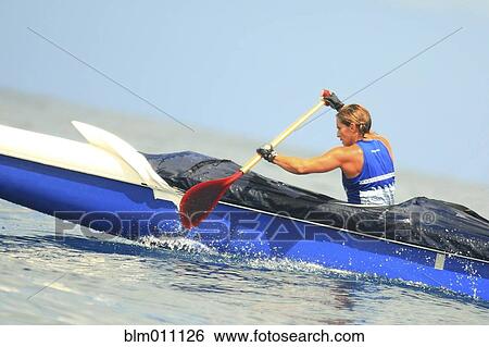 Stock Photograph - Caucasian woman paddling canoe. Fotosearch