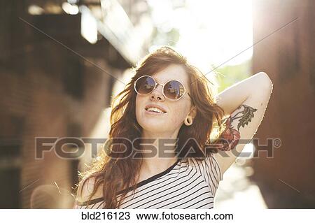 Stock Image - Caucasian woman posing in city. Fotosearch