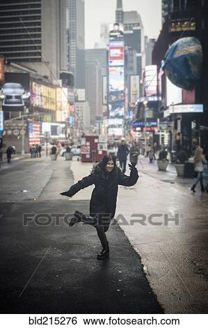 Stock Photograph - Caucasian woman posing in Times square, New York, New York, United States. Fotosearch