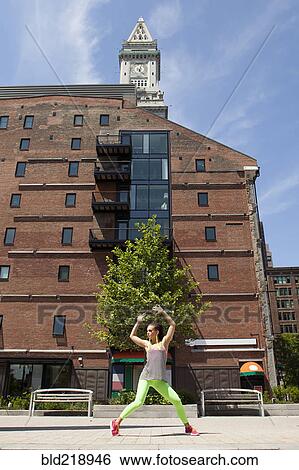 Stock Photograph - Caucasian woman posing on city sidewalk. Fotosearch
