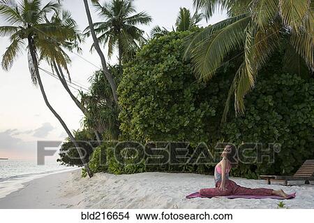 Caucasian woman practicing yoga on tropical beach View Large Photo Image Picture - Caucasian woman practicing yoga on tropical beach. Fotosearch