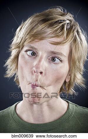 Stock Photo - Caucasian woman puckering her mouth. Fotosearch