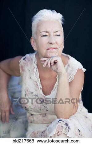 Stock Photo - Caucasian woman resting chin in hand. Fotosearch
