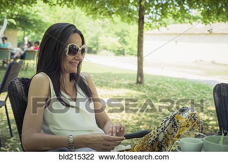 Caucasian woman sitting in chair in backyard View Large Photo Image Stock Image - Caucasian woman sitting in chair in backyard. Fotosearch