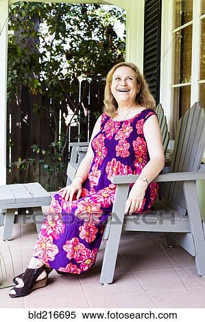 Stock Photography - Caucasian woman sitting on porch. Fotosearch