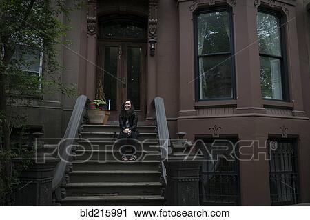 Caucasian woman sitting on townhouse front stoop View Large Photo Image Stock Image - Caucasian woman sitting on townhouse front stoop. Fotosearch