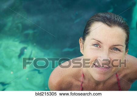 Caucasian woman smiling in swimming pool View Large Photo Image Stock Photography - Caucasian woman smiling in swimming pool. Fotosearch