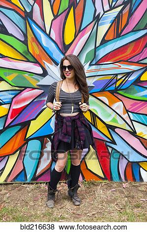 Caucasian woman smiling near multicolor mural View Large Photo Image Stock Photo - Caucasian woman smiling near multicolor mural. Fotosearch