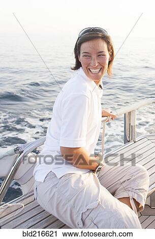 Caucasian woman smiling on boat deck View Large Photo Image Stock Image - Caucasian woman smiling on boat deck. Fotosearch