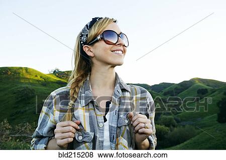Stock Photo - Caucasian woman smiling on rural hilltop. Fotosearch