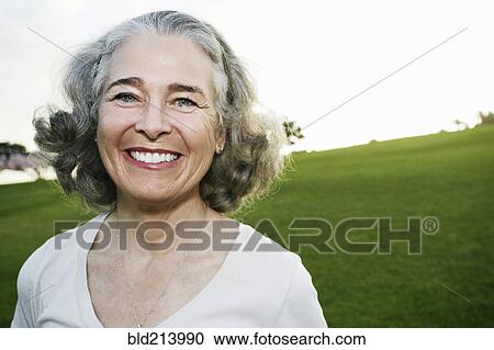 Caucasian woman smiling outdoors View Large Photo Image Stock Image - Caucasian woman smiling outdoors. Fotosearch