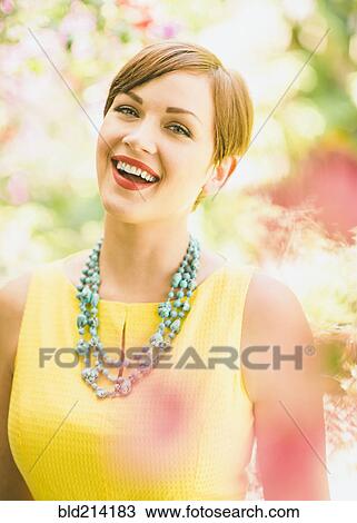 Stock Image - Caucasian woman smiling outdoors. Fotosearch