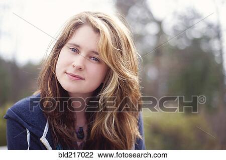 Stock Image - Caucasian woman smiling outdoors. Fotosearch