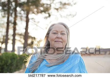 Caucasian woman smiling outdoors View Large Photo Image Stock Photo - Caucasian woman smiling outdoors. Fotosearch