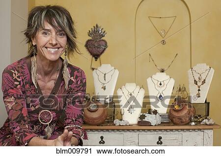 Caucasian woman standing by jewelry display View Large Photo Image Stock Image - Caucasian woman standing by jewelry display. Fotosearch