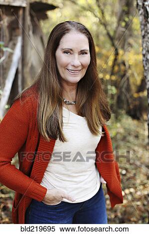 Caucasian woman standing in backyard View Large Photo Image Stock Photography - Caucasian woman standing in backyard. Fotosearch