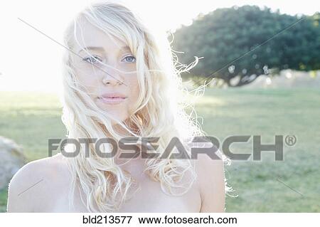 Stock Photo - Caucasian woman standing in field. Fotosearch