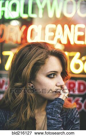 Caucasian woman standing in front of neon sign View Large Photo Image Stock Photo - Caucasian woman standing in front of neon sign. Fotosearch