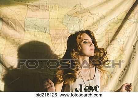 Stock Photograph - Caucasian woman standing in front of fabric map. Fotosearch