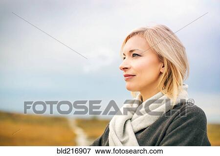 Stock Photo - Caucasian woman standing in rural field. Fotosearch