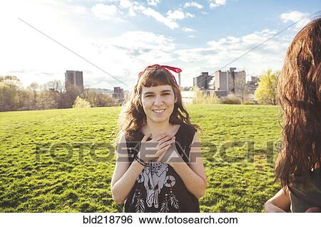 Stock Photograph - Caucasian woman standing in urban park. Fotosearch