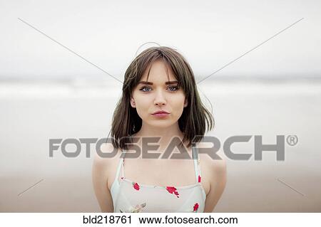 Caucasian woman standing on beach View Large Photo Image Stock Image - Caucasian woman standing on beach. Fotosearch