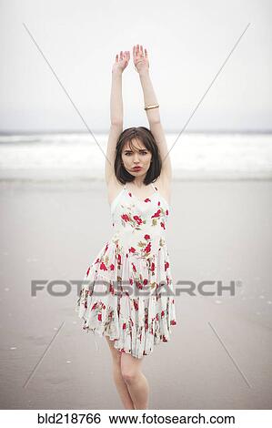 Stock Photograph - Caucasian woman standing on beach. Fotosearch
