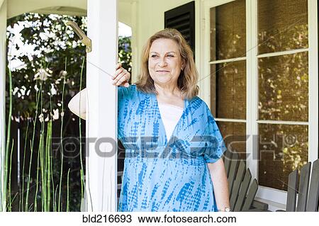 Caucasian woman standing on porch View Large Photo Image Stock Image - Caucasian woman standing on porch. Fotosearch