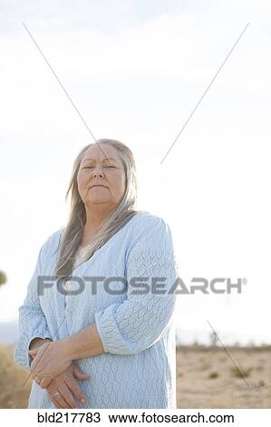 Caucasian woman standing outdoors View Large Photo Image Stock Image - Caucasian woman standing outdoors. Fotosearch
